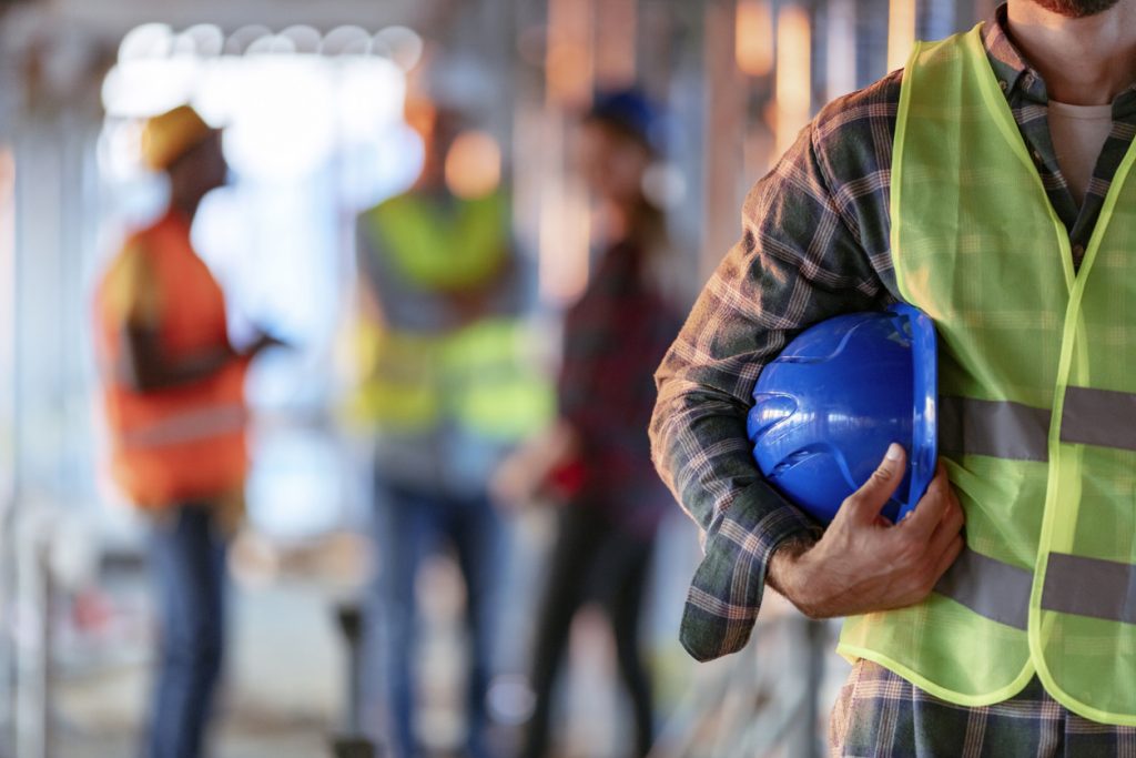 holding helmet on work site