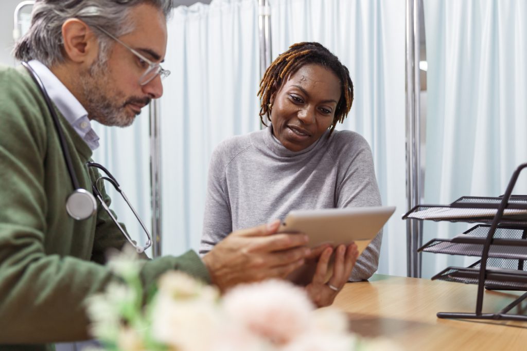 female patient reviewing test results with doctor